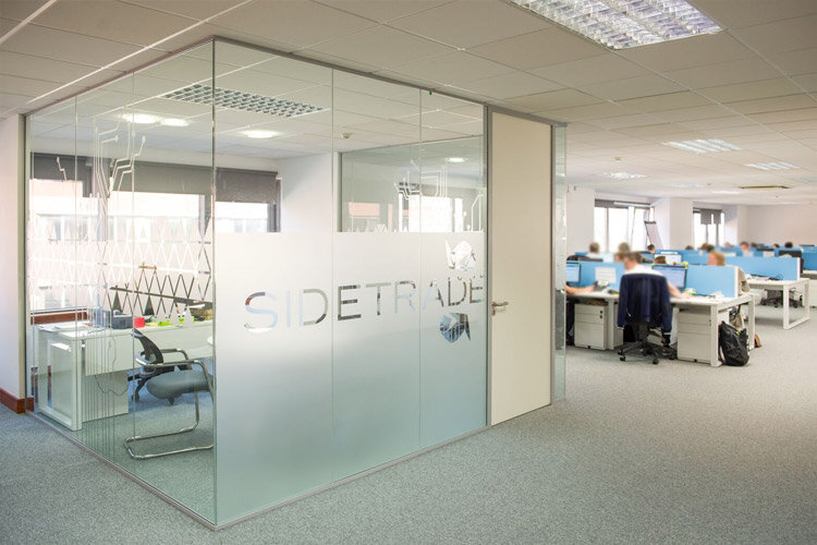 glazed partition wall with sidetrade logo